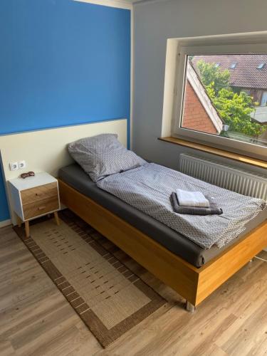 a bed in a room with a window at Haus am Sandhügel in Lingen