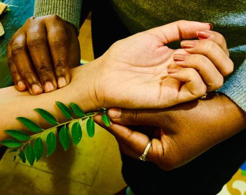 a woman is holding the hands of another woman at Sanskriti Vedic Retreat in Rishīkesh