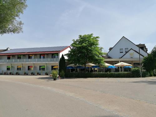a large building with umbrellas in front of it at Gasthaus Pension Rezatgrund in Windsbach