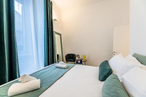 a bedroom with a bed with two towels on it at My Luxury Suites - Executive in Savona