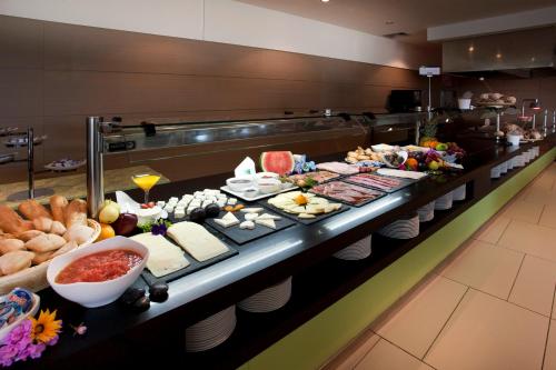 a buffet line with many different types of food at La Finca Resort in Algorfa