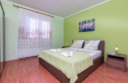 a bedroom with a bed with two towels on it at Apartment Rubina with secure parking in Medulin