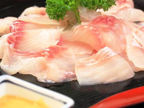 a close up of a bunch of meat on a grill at Oyado Fubuki in Nozawa Onsen