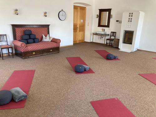 a living room with four yoga mats on the floor at Maria Waldrast in Matrei am Brenner