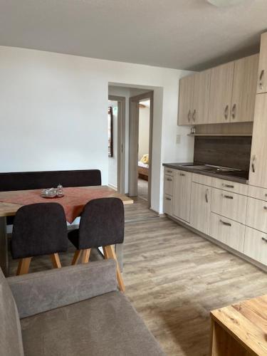 a kitchen with a table and chairs in a room at Rimls Landhaus in Sölden
