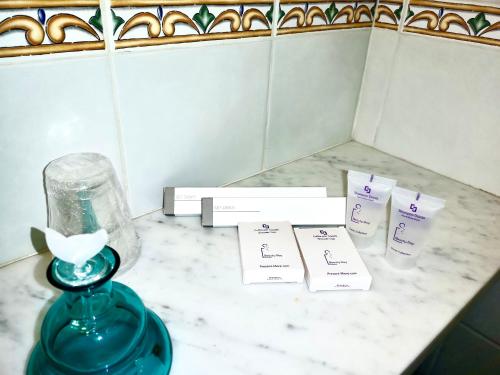 a blue vase sitting on a counter with two cards at Villa Giannina B&B in Taormina