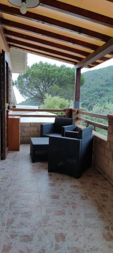 a patio with couches and a view of a mountain at Locanda Mossa Dei Barbari in Buriano