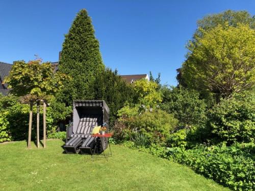 a chair sitting in the grass in a yard at Hotel F-RITZ in Schleswig