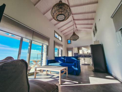 a living room with a blue couch and a table at Owl Villas in Drymon