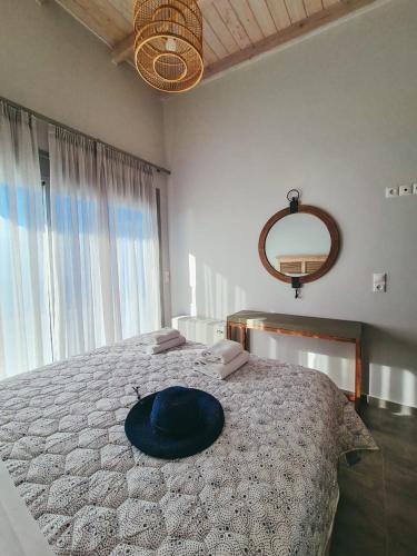 a bedroom with a bed with a blue hat on it at Owl Villas in Drymon