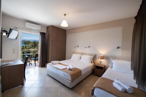 a hotel room with two beds and a balcony at Aurora Studios in Nikiana