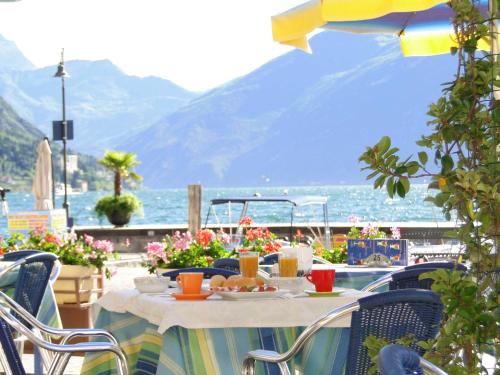 a table with a plate of food on top of a balcony at Hotel Sole - Limone in Limone sul Garda