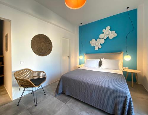 a bedroom with a bed and a chair at Marton Perissa in Perissa