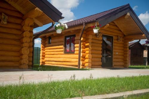 a log cabin with two doors and a porch at Christiana-Rent in Cristian