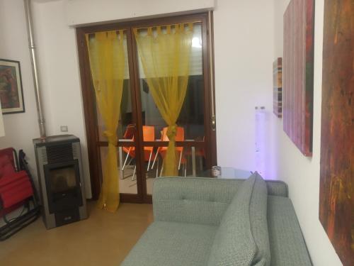 a living room with a couch and a window at Fronte mare in Marotta