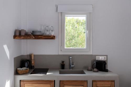 a kitchen with a sink and a window at Drios Luxury Studios in Drios