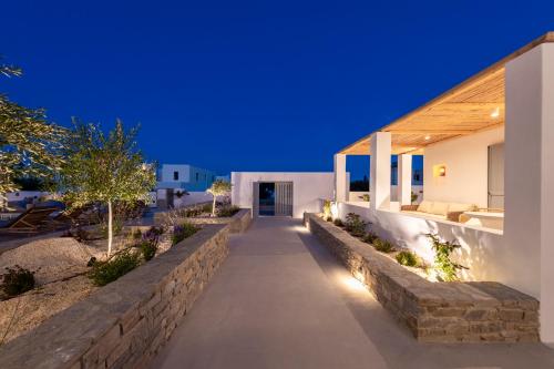 a pathway leading to a house at night at Drios Luxury Studios in Drios