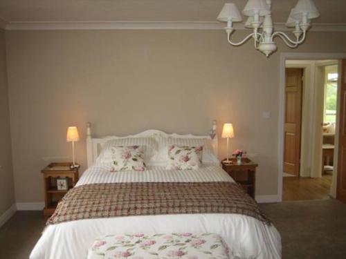 a bedroom with a large bed with two pillows at Ladderstile Retreat in Congleton