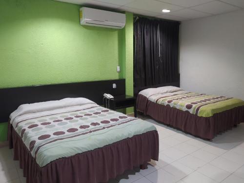 Postel nebo postele na pokoji v ubytování Hotel y Restaurante Ritz de Tabasco