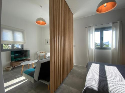 a bedroom with a bed and a tv in a room at Marton Perissa in Perissa