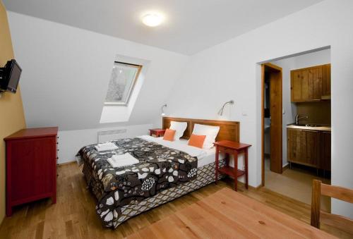a bedroom with a bed and a table in a room at Penzion Blanko in Nová Bystřice