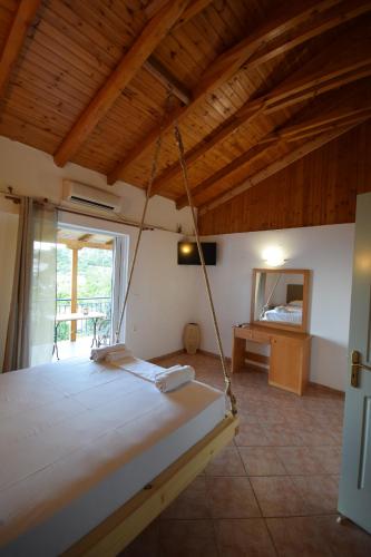 a bedroom with a swinging bed in a room at Elena's Family Apartments in Leonidion