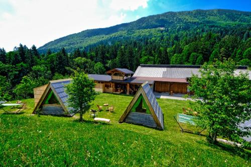 an image of a house in a field of grass at Glamping Brodej in Vitanje