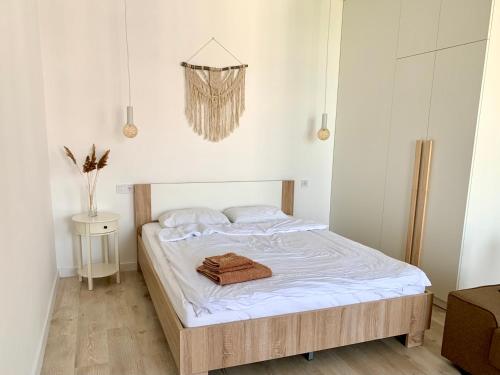 a bedroom with a bed with a towel on it at Boho квартира у моря ЖК Парк Фонтанов in Fontanka