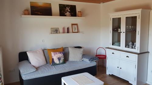 a living room with a couch and a cabinet at Wohnung Wiesengrün - Osserblick in Lam