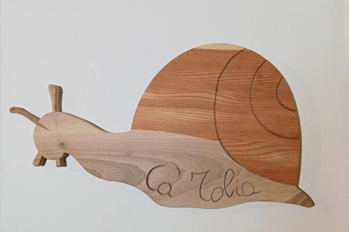 a wooden whale shaped sign with the word aloha at Ca' Tobia in Teolo