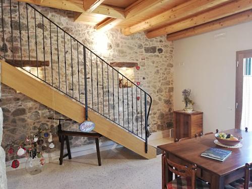 a living room with a staircase and a table at Ca' Tobia in Teolo