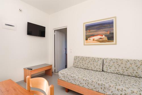 a living room with a couch and a table at Matina Pefkos Aparthotel in Pefki Rhodes