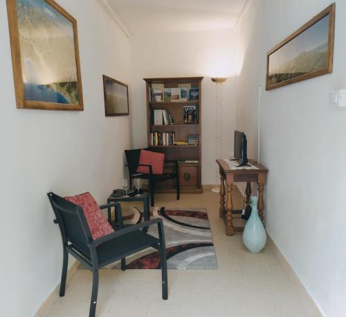 a living room with a chair and a table at CASA SILVANA in Equi Terme