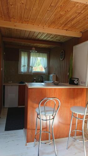 a kitchen with two chairs and a counter top at BpR P3 Lodge Apartment with A/C in Budapest