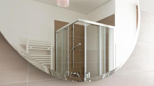 a mirror hanging on a wall in a bathroom at Italianway - Villa Tola in Valdisotto
