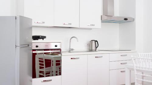 a white kitchen with a sink and a refrigerator at Italianway - Villa Tola in Valdisotto