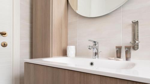 a bathroom with a sink and a mirror at Italianway - Villa Tola in Valdisotto