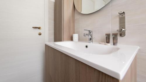 a bathroom with a white sink and a mirror at Italianway - Villa Tola in Valdisotto