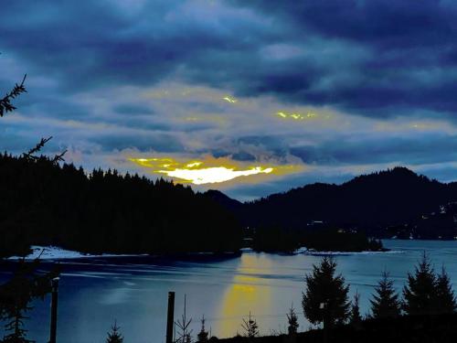 a view of a river at night with a cloudy sky at Chalet du Lac in Colibiţa
