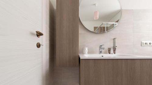 a bathroom with a sink and a mirror at Italianway - Villa Tola in Valdisotto
