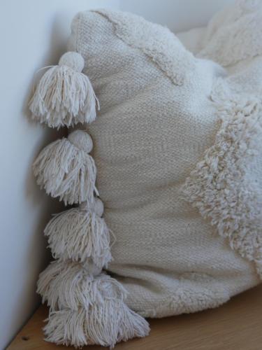 a pile of white mounds of wool on a pillow at Harbour View House in St Ives
