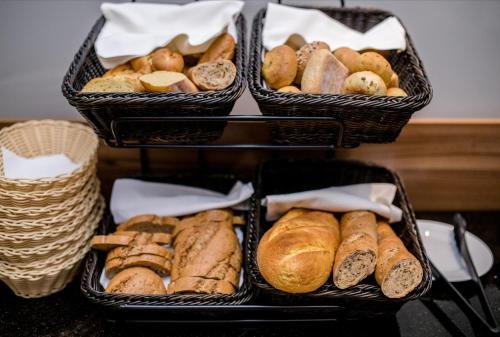 three baskets filled with different types of bread at B&B Vila Sabbia in Lopar