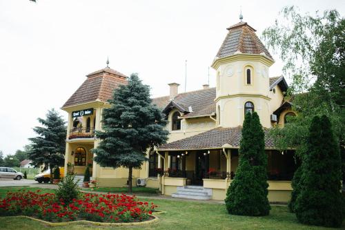 a large house with a clock tower on top of it at Kronić Palace in Sombor