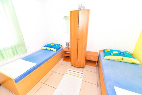 Postel nebo postele na pokoji v ubytování Apartments Emma
