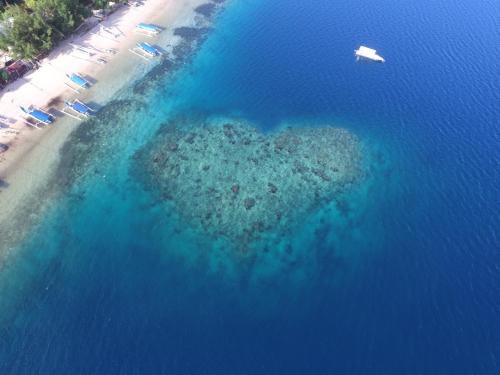 an aerial view of a small island in the ocean at Amahelia Luxury Resort & Restaurant - Gili Asahan in Gili Asahan