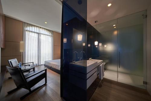 a bathroom with a sink and a desk and a bed at Mercer Casa Torner i Güell in Vilafranca del Penedès