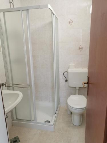 a bathroom with a shower and a toilet and a sink at Litus in Njivice