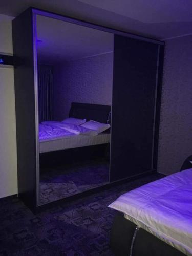 a mirror in a room with two beds in a bedroom at Ely's Mansion-24h Check-in in Bucharest