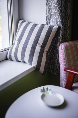 a pillow sitting on a couch next to a table at Alsóörs Pagony in Alsóörs