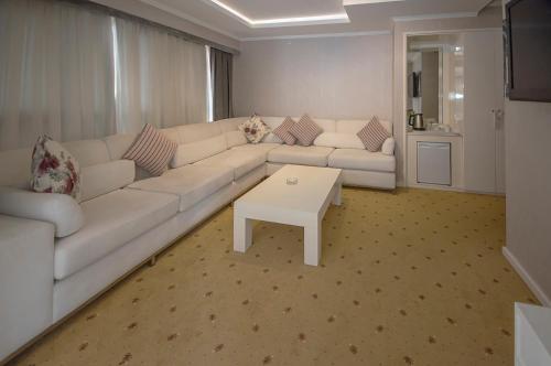 a living room with a white couch and a table at NK Hotel in Izmir